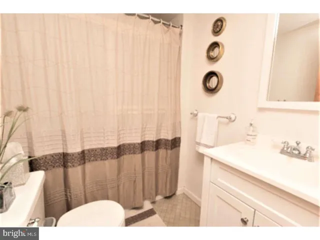 a view of a livingroom with furniture and bookshelf