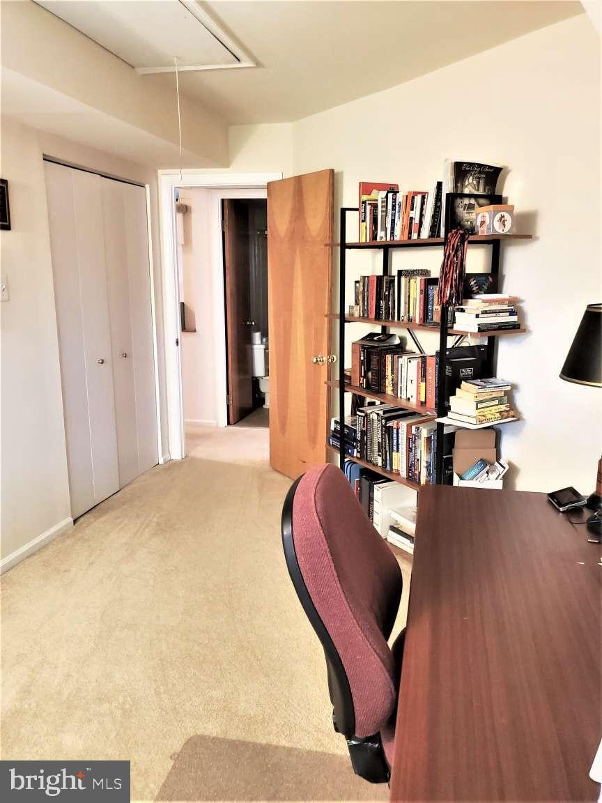 8 Rex Avenue, Unit 11 Philadelphia, PA 19118 - Photo 16 of 25 a view of a livingroom with furniture and bookshelf