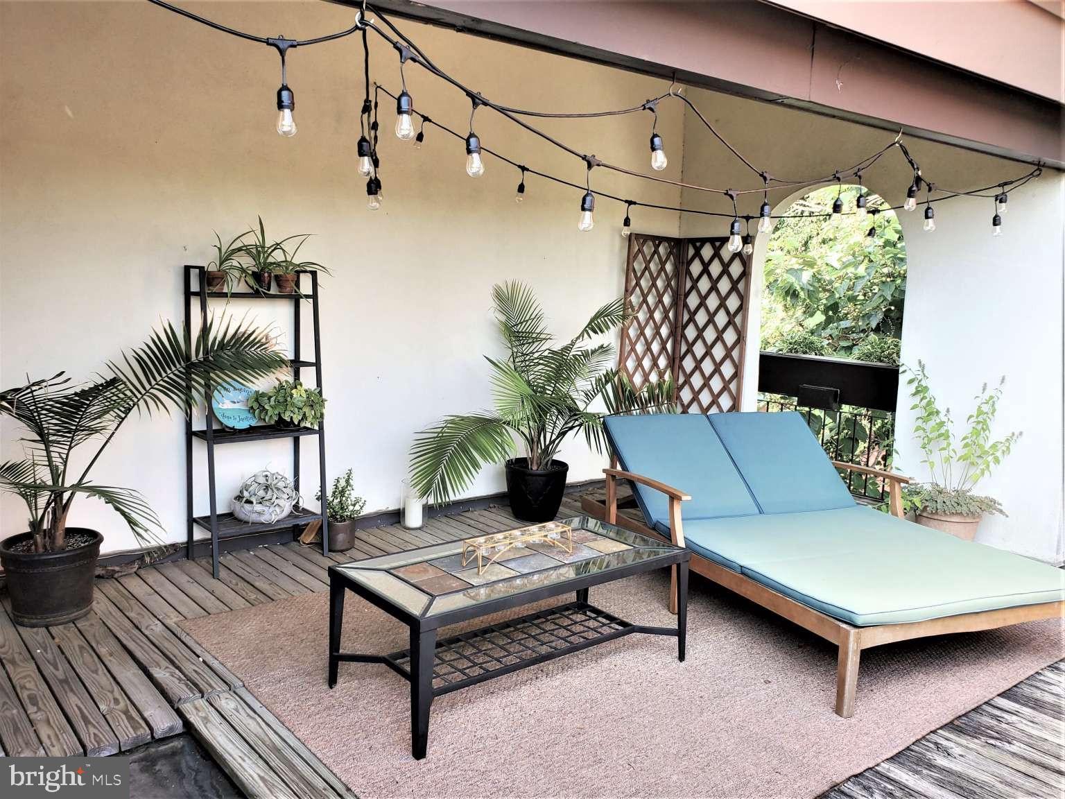8 Rex Avenue, Unit 11 Philadelphia, PA 19118 - Photo 20 of 25 a outdoor living space with furniture and a potted plant