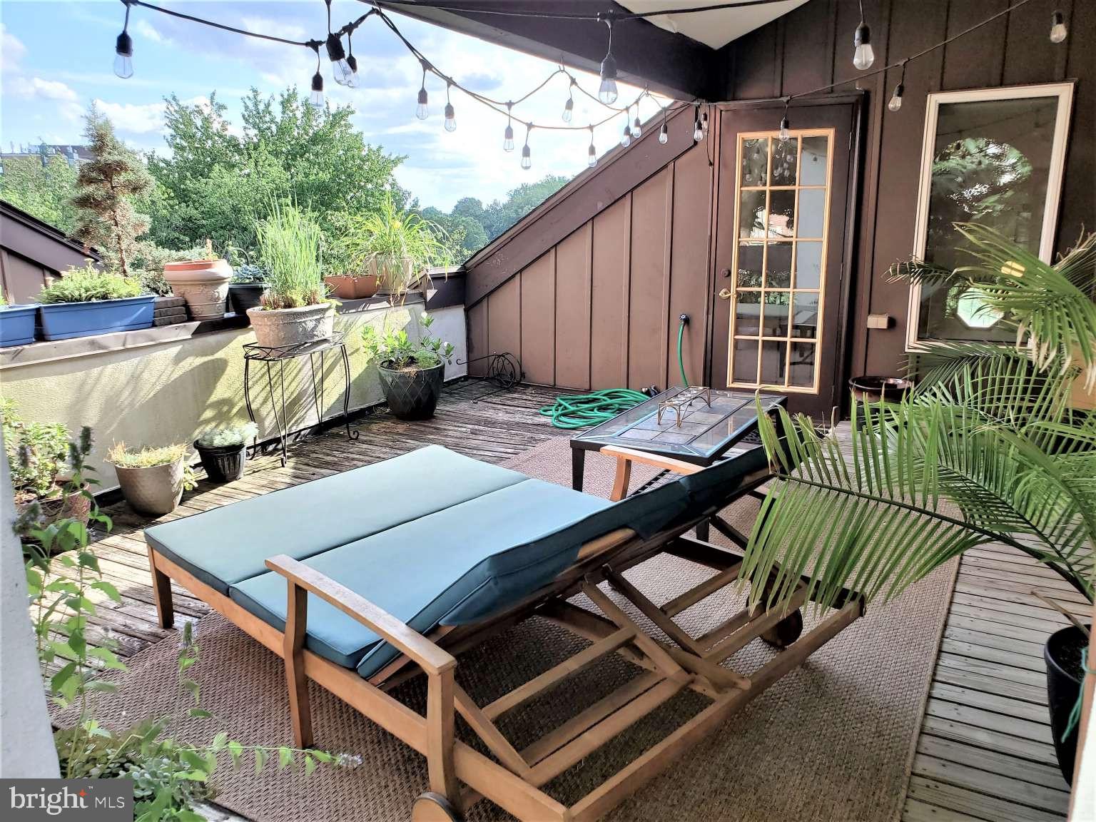 8 Rex Avenue, Unit 11 Philadelphia, PA 19118 - Photo 21 of 25 a view of an outdoor sitting area with brick walls