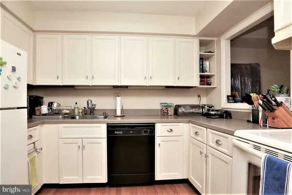 a kitchen with stainless steel appliances granite countertop a sink a stove and cabinets