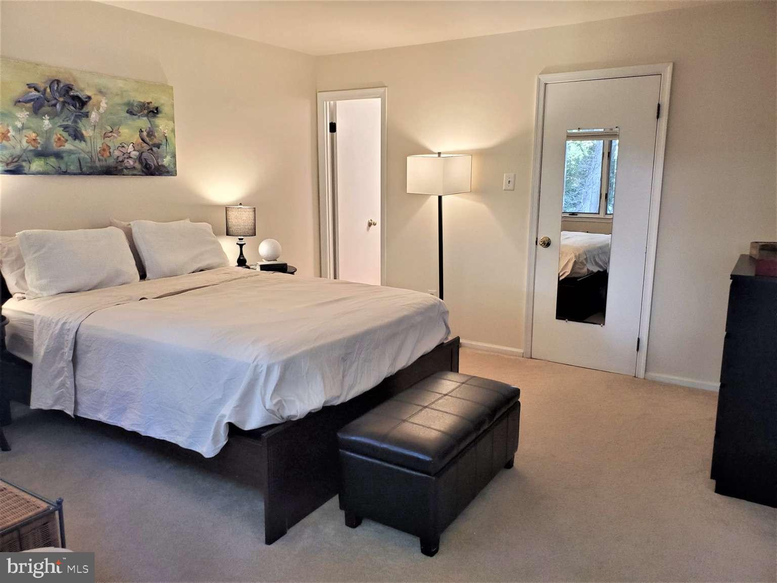 8 Rex Avenue, Unit 11 Philadelphia, PA 19118 - Photo 10 of 25 a bedroom with a bed and a painting on the wall