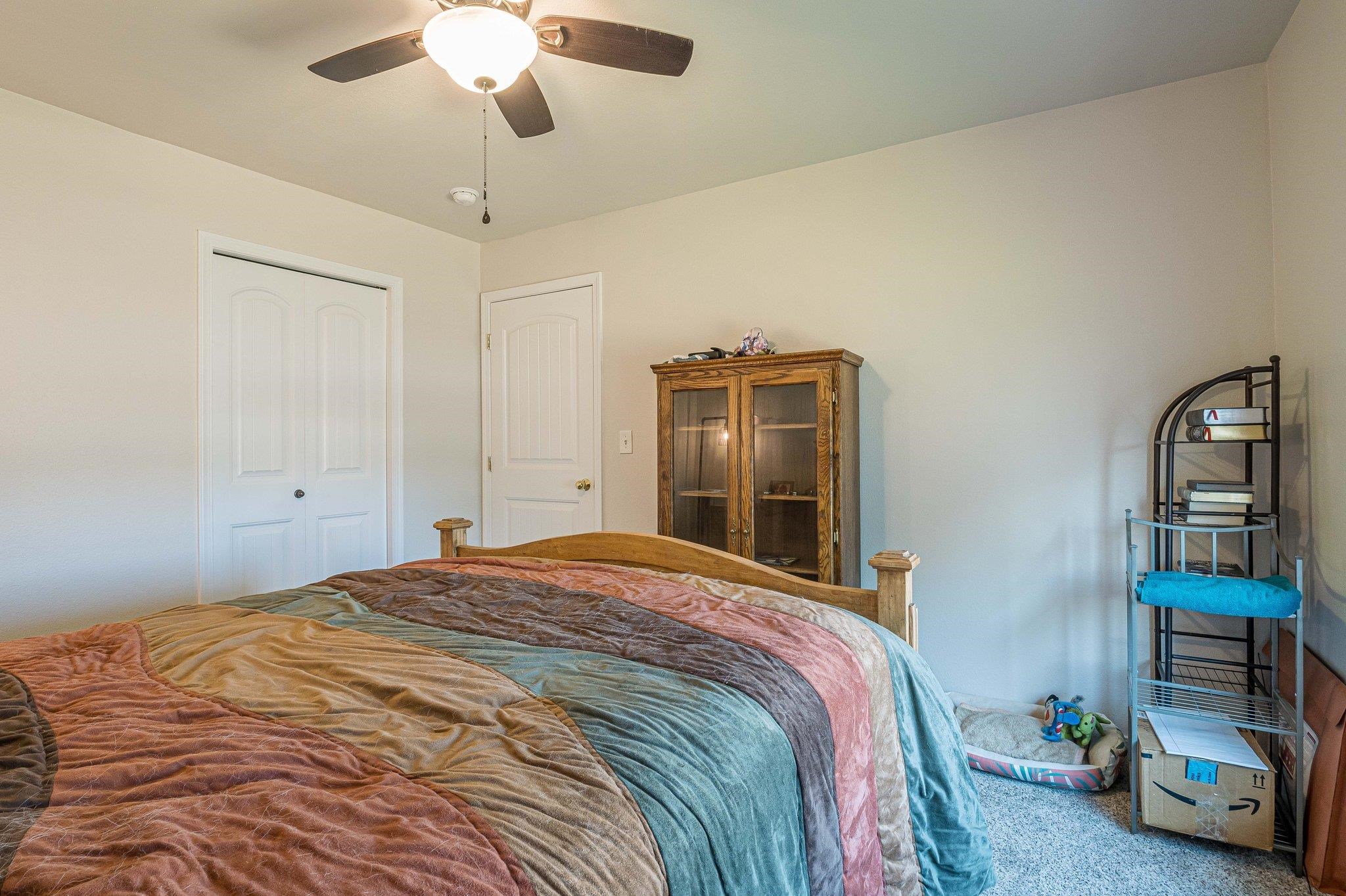 424 1/2 29 1/2 Road Grand Junction, CO 81504 - Photo 21 of 40 a bedroom with a bed closet and a chandelier