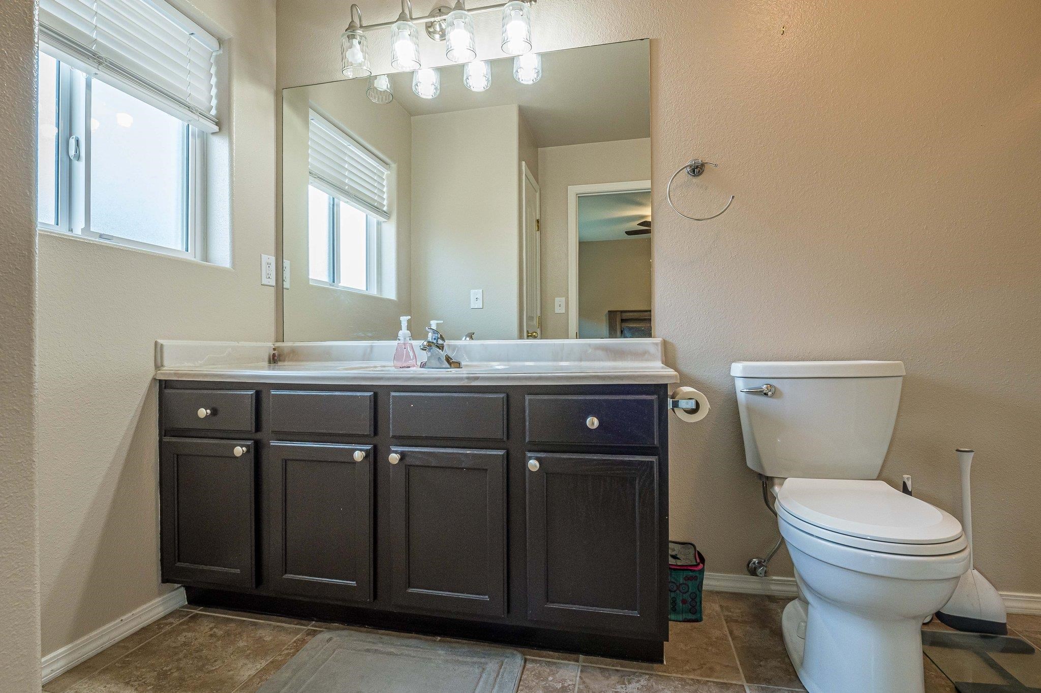 424 1/2 29 1/2 Road Grand Junction, CO 81504 - Photo 27 of 40 a bathroom with a sink vanity mirror and toilet