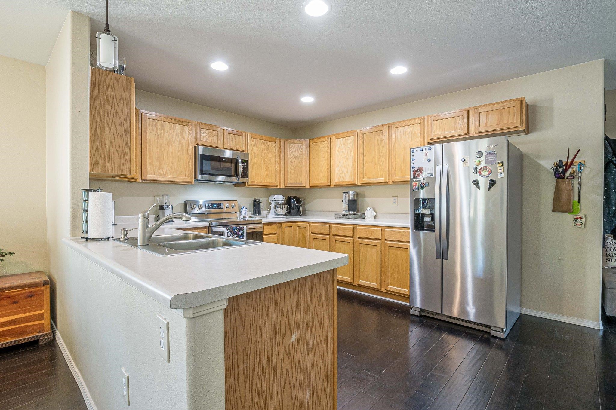 424 1/2 29 1/2 Road Grand Junction, CO 81504 - Photo 6 of 40 a kitchen with a refrigerator a sink and a microwave