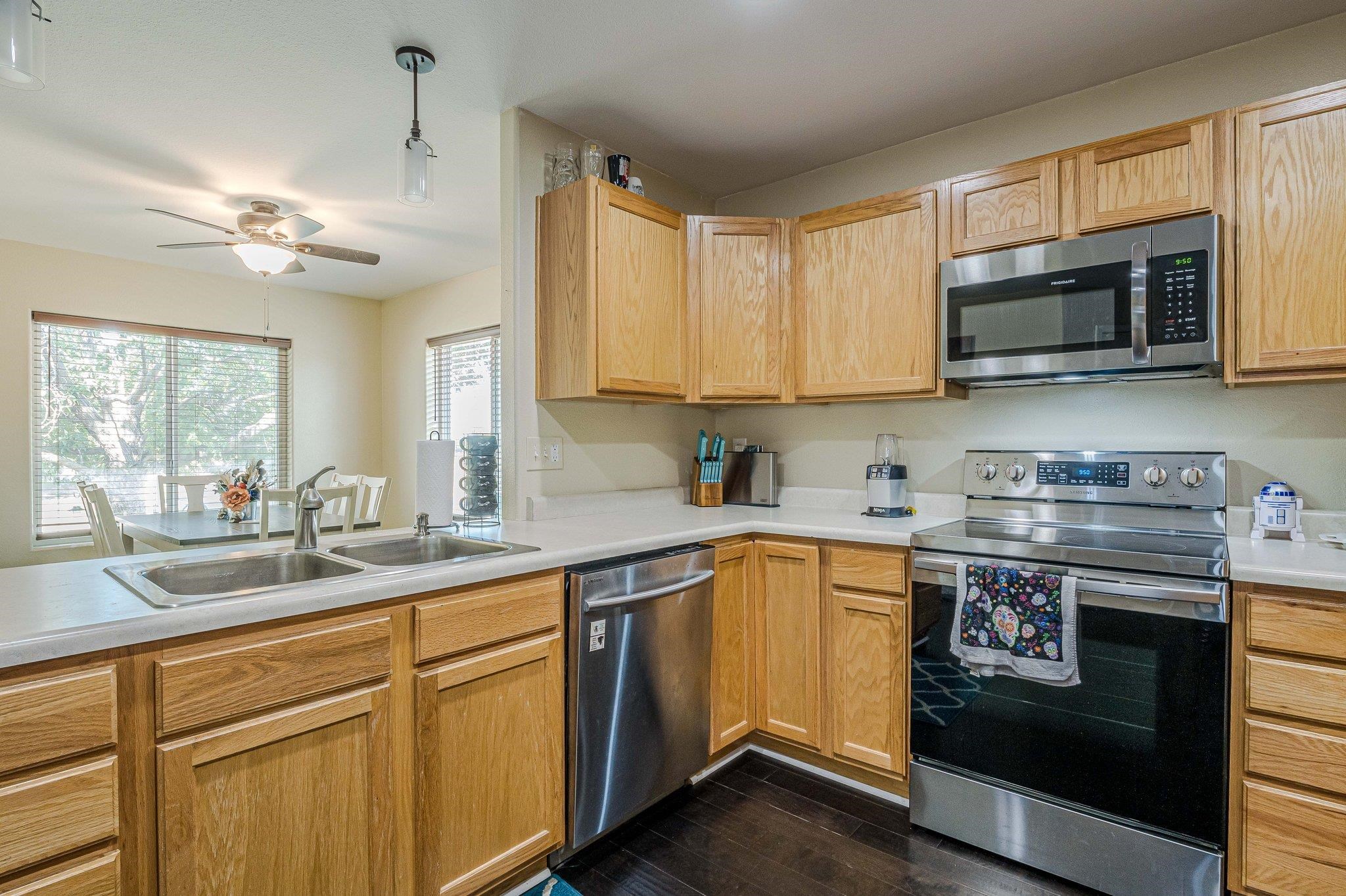 424 1/2 29 1/2 Road Grand Junction, CO 81504 - Photo 8 of 40 a kitchen with stainless steel appliances granite countertop a stove a sink and a microwave