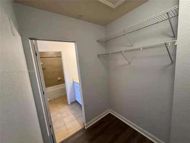 a bathroom with a sink a toilet a mirror and shower