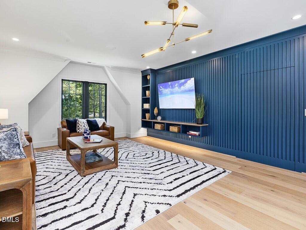 7013 Buckhead Drive Raleigh, NC 27615 - Photo 52 of 80 a living room with furniture and a flat screen tv