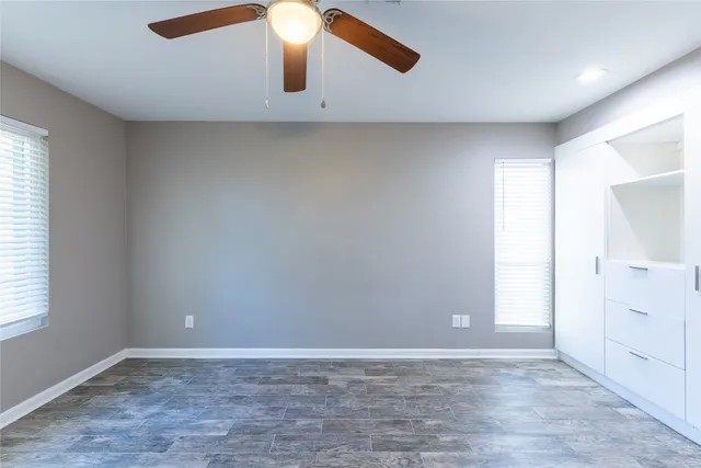 an empty room with a empty space and windows