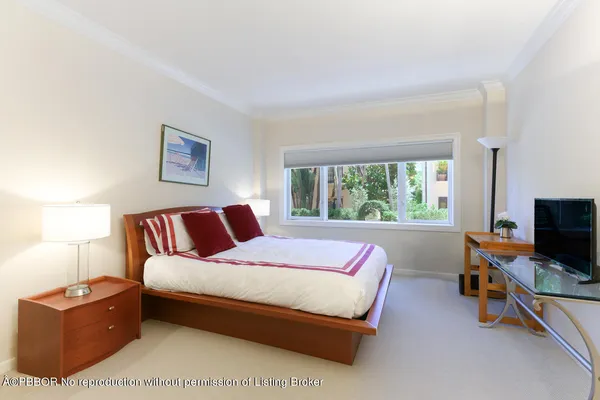 a spacious bedroom with a bed and a window
