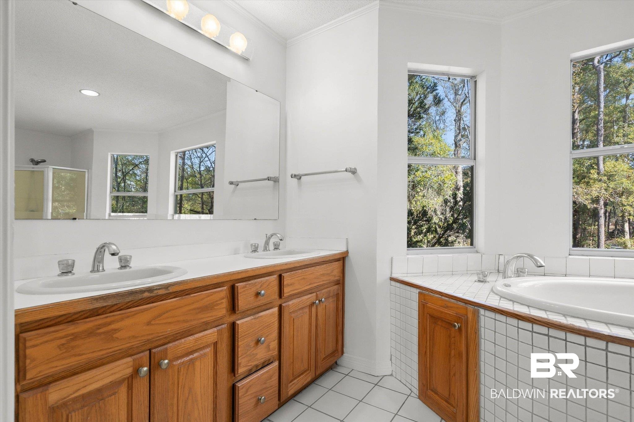 3847 Riviere Du Chien Road Mobile, AL 36693 - Photo 19 of 51 Bathroom featuring double vanity, a bath, light tile patterned flooring, and crown molding