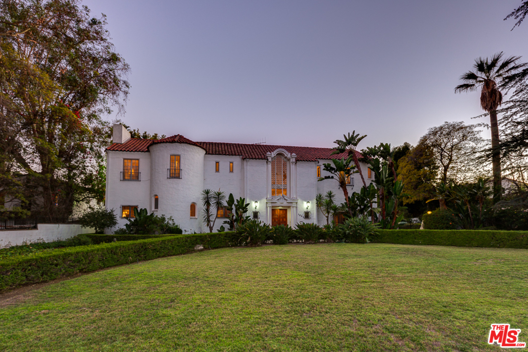 1003 Benedict Canyon Drive Beverly Hills, CA 90210 - Photo 1 of 35 a front view of house with yard and green space