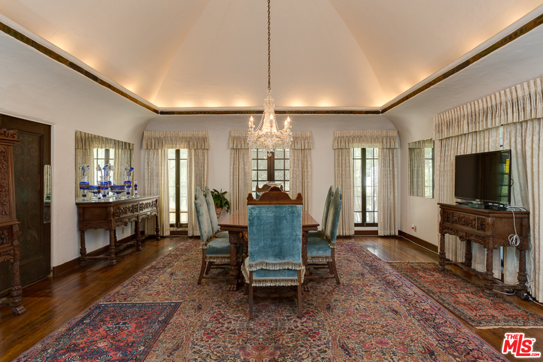 1003 Benedict Canyon Drive Beverly Hills, CA 90210 - Photo 13 of 35 a living room with furniture and a flat screen tv