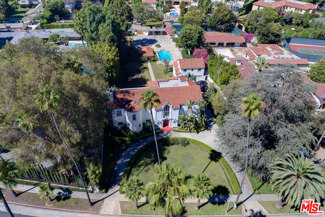 1003 Benedict Canyon Drive Beverly Hills, CA 90210 - Photo 3 of 35 an aerial view of a house with a yard
