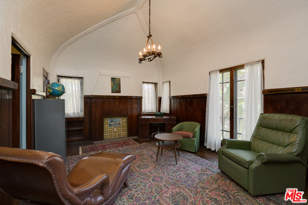 1003 Benedict Canyon Drive Beverly Hills, CA 90210 - Photo 25 of 35 a living room with furniture and a fireplace