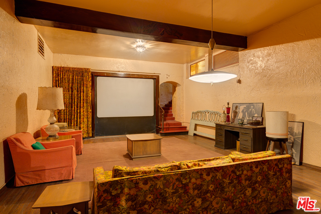 1003 Benedict Canyon Drive Beverly Hills, CA 90210 - Photo 27 of 35 a living room with a couch and a table