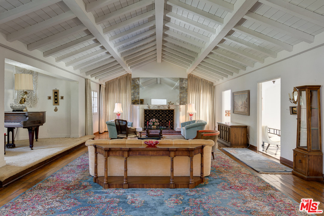 1003 Benedict Canyon Drive Beverly Hills, CA 90210 - Photo 5 of 35 a living room with fireplace furniture and a rug