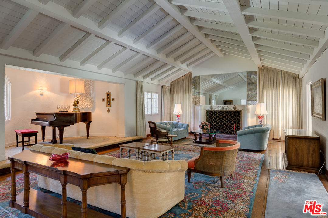 1003 Benedict Canyon Drive Beverly Hills, CA 90210 - Photo 6 of 35 a living room with fireplace furniture and a flat screen tv