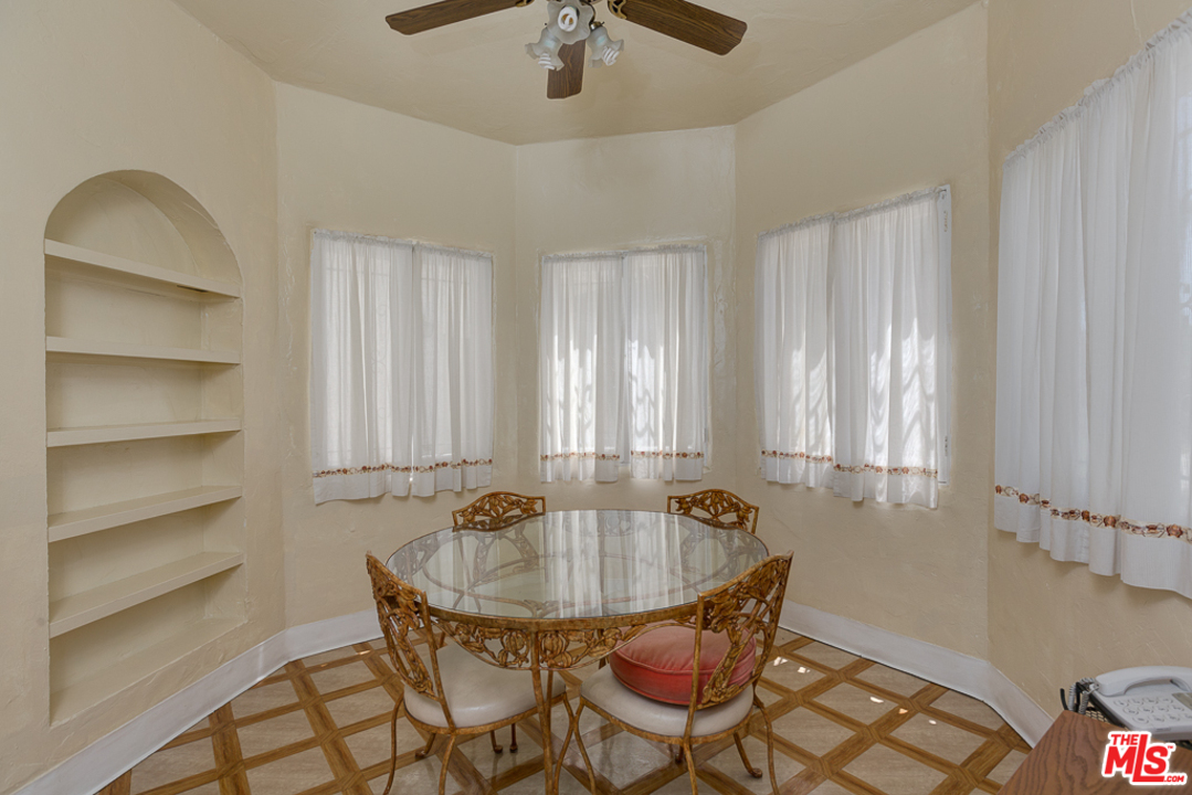 1003 Benedict Canyon Drive Beverly Hills, CA 90210 - Photo 10 of 35 a view of a dining room with furniture and chandelier