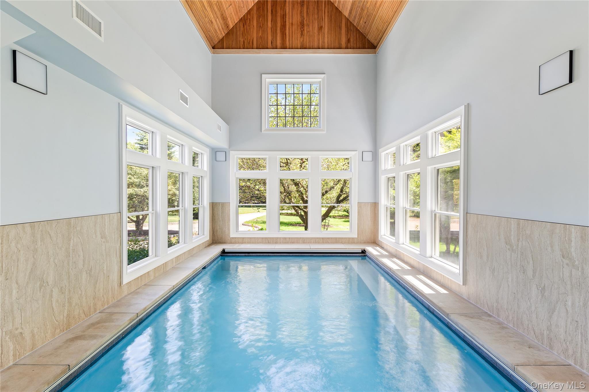 42 Mamaroneck Road Scarsdale, NY 10583 - Photo 22 of 47 Your own year-round wellness retreat features a spectacular heated indoor pool with soaring vaulted wood ceilings, radiant heated floors, endless swim current, integrated spa, and abundant natural light from three exposures.