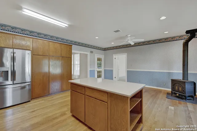 a kitchen with a refrigerator and a sink