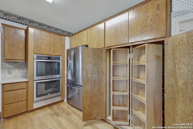 a kitchen with stainless steel appliances a refrigerator and cabinets