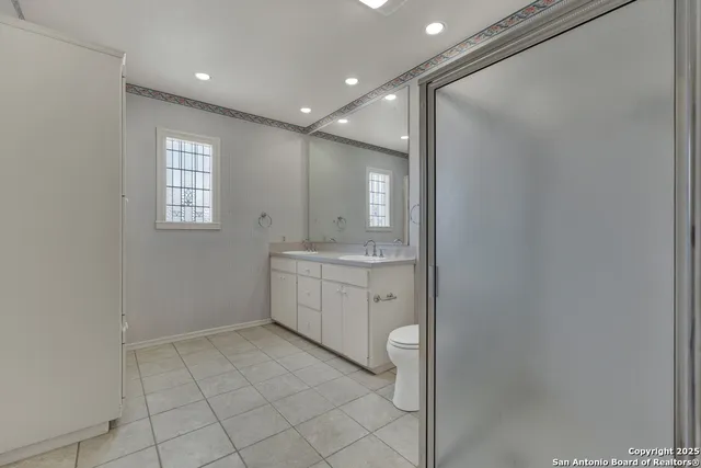 a bathroom with a sink a toilet and mirror