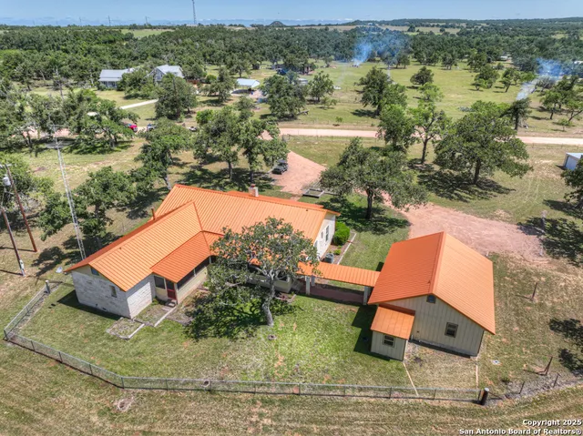 an aerial view of a house with outdoor space and lake view