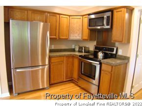 241 Hardy Road Carthage, NC 28327 - Photo 3 of 12 a kitchen with a refrigerator and a sink