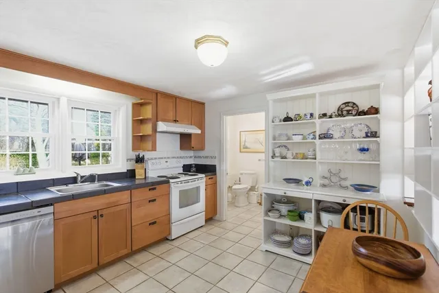 a kitchen with stainless steel appliances granite countertop a sink and cabinets