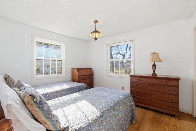 a bedroom with a bed dresser and a window