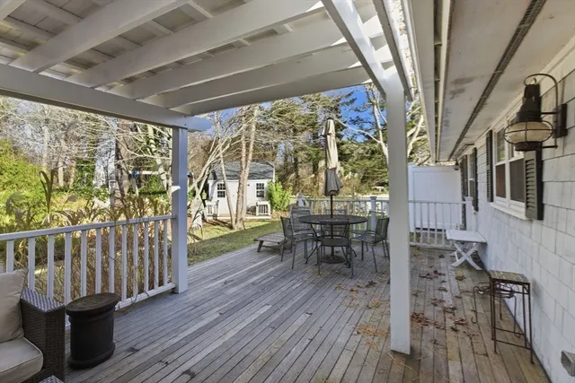 a view of a porch with furniture and wooden floor