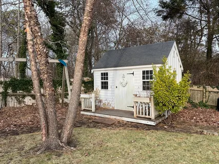 a view of a house with a tree in the yard