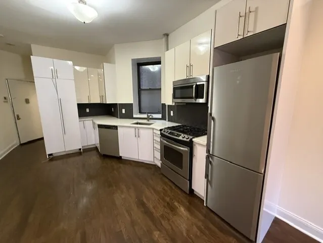 a kitchen with stainless steel appliances a refrigerator stove microwave and sink