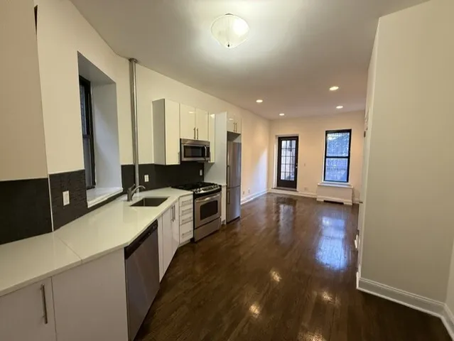 a large kitchen with a large counter top appliances and cabinets