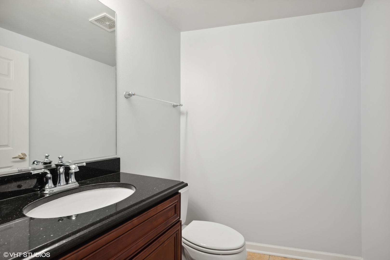 701 West Rand Road, Unit 330 Arlington Heights, IL 60004 - Photo 13 of 16 a bathroom with a granite countertop sink toilet and a mirror