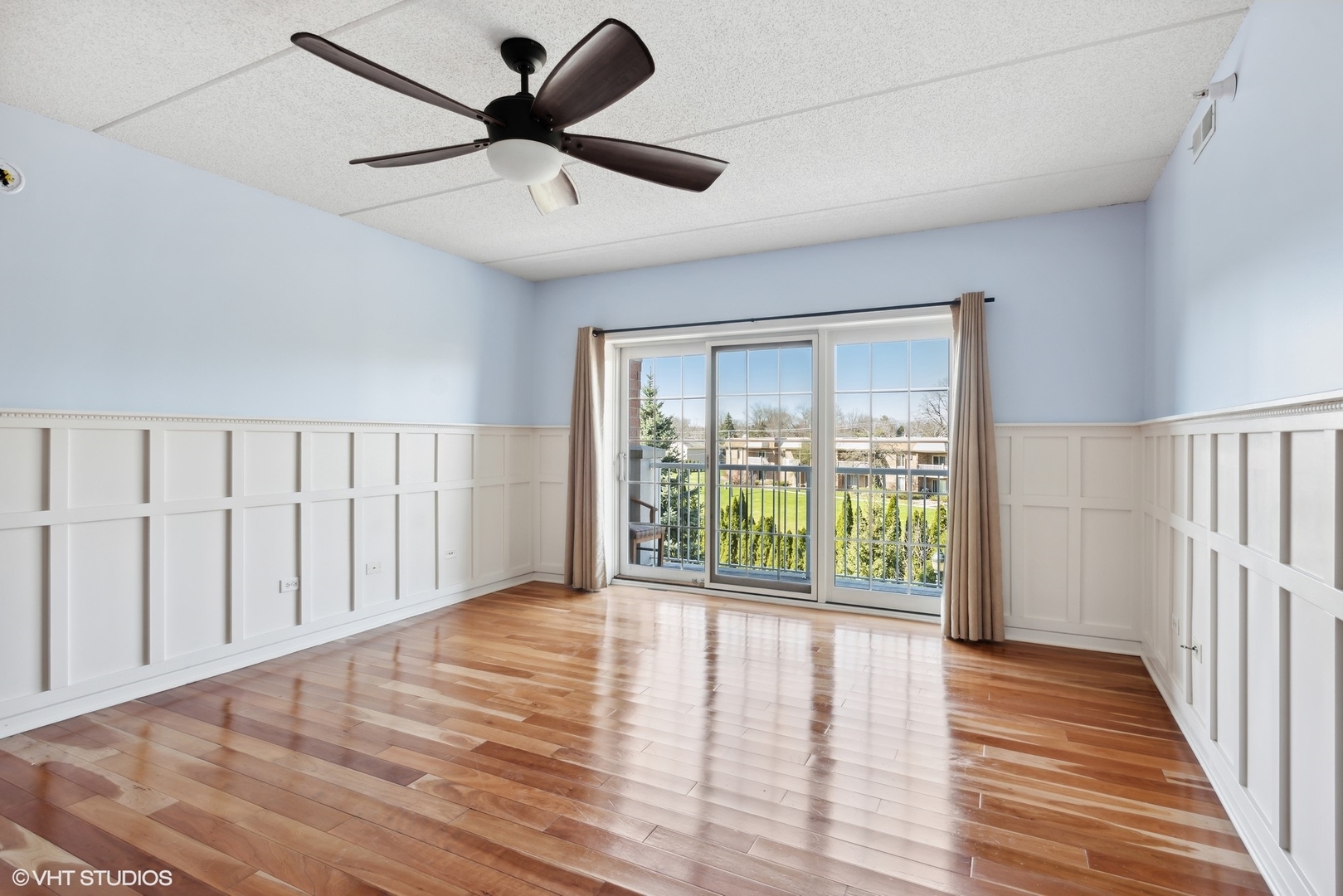 701 West Rand Road, Unit 330 Arlington Heights, IL 60004 - Photo 3 of 16 a view of an empty room with wooden floor and a window