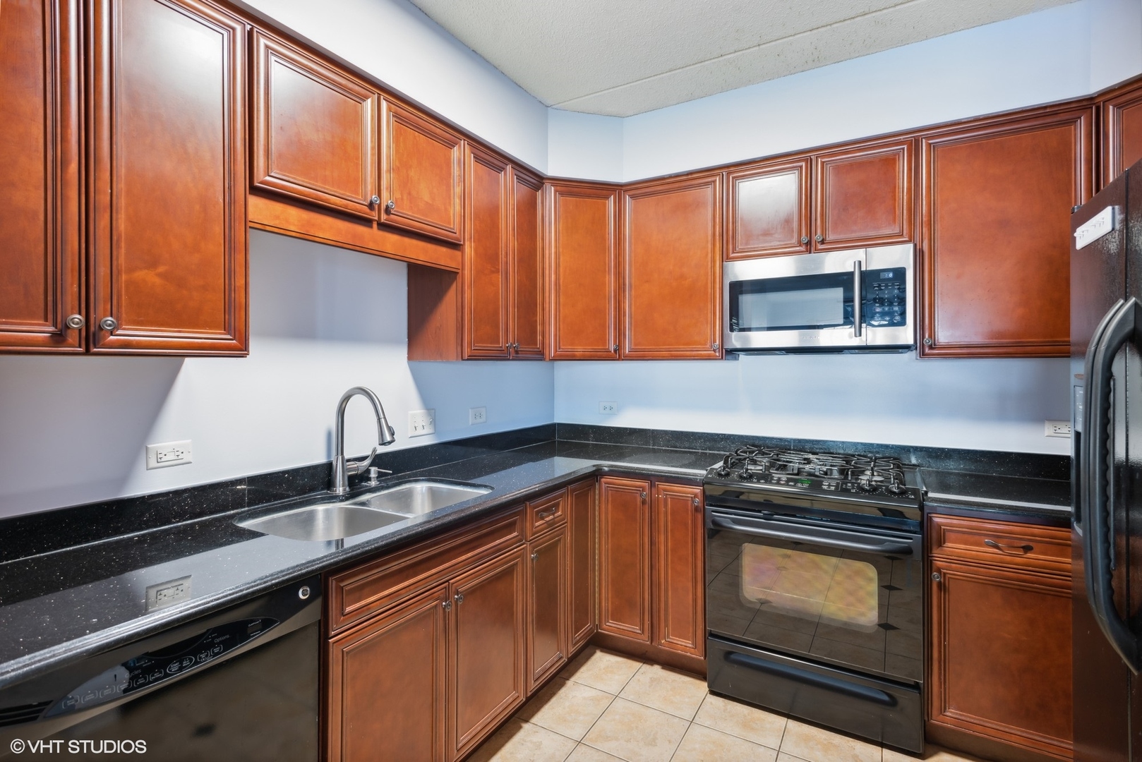 701 West Rand Road, Unit 330 Arlington Heights, IL 60004 - Photo 6 of 16 a kitchen with stainless steel appliances granite countertop a sink stove and microwave