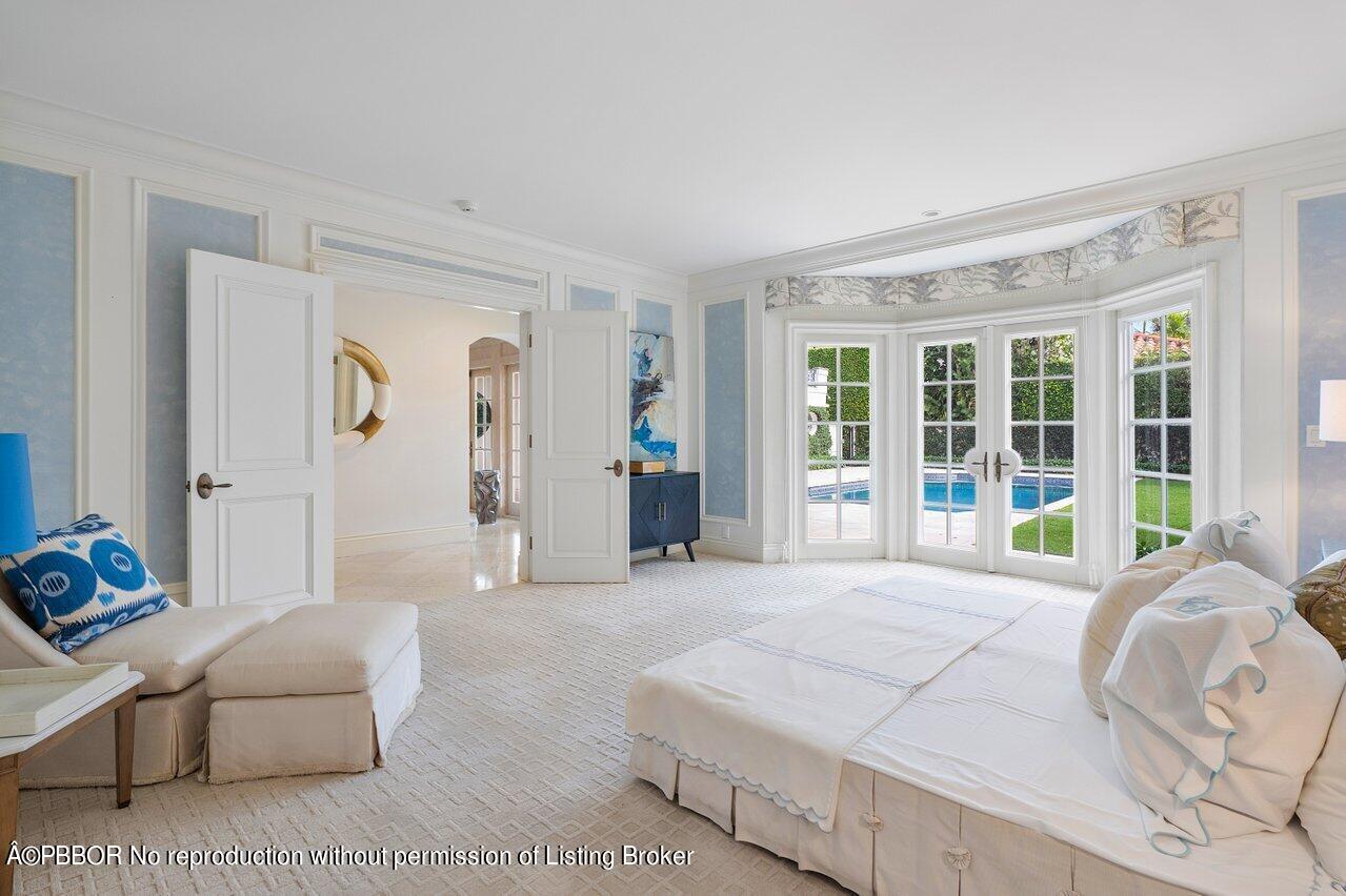 168 Kings Road Palm Beach, FL 33480 - Photo 28 of 51 a spacious bedroom with a bed and glass window