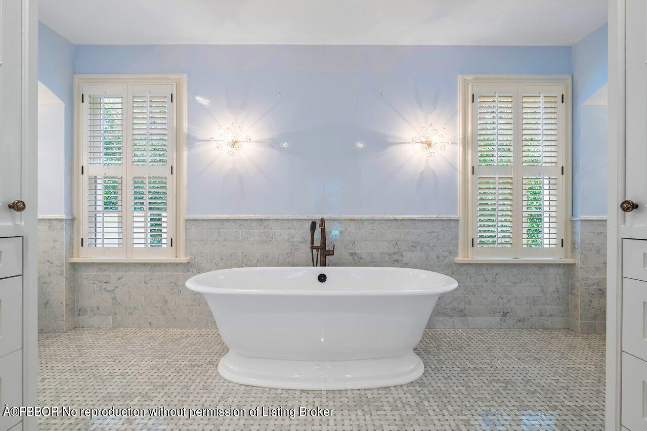 168 Kings Road Palm Beach, FL 33480 - Photo 33 of 51 a white bath tub sitting in a bathroom next to a window