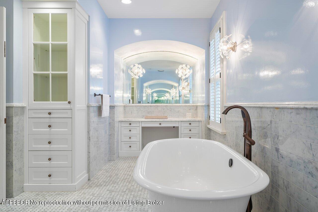 168 Kings Road Palm Beach, FL 33480 - Photo 34 of 51 a bathroom with a sink a mirror and a bathtub