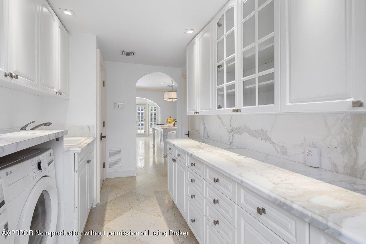 168 Kings Road Palm Beach, FL 33480 - Photo 45 of 51 a view of a kitchen with a sink washer and dryer