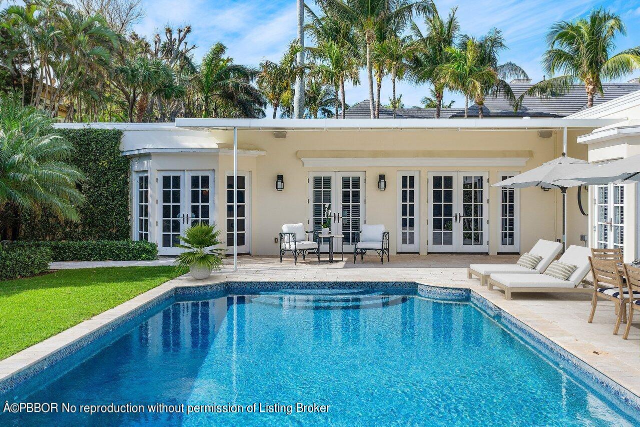 168 Kings Road Palm Beach, FL 33480 - Photo 48 of 51 a view of a house with swimming pool and porch with furniture