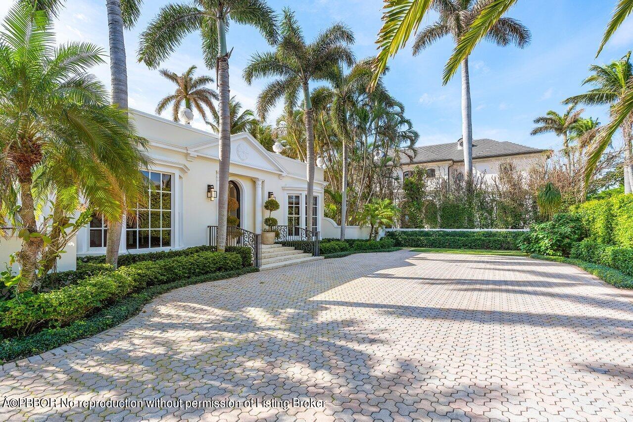 168 Kings Road Palm Beach, FL 33480 - Photo 7 of 51 a view of a white house with a yard and palm trees