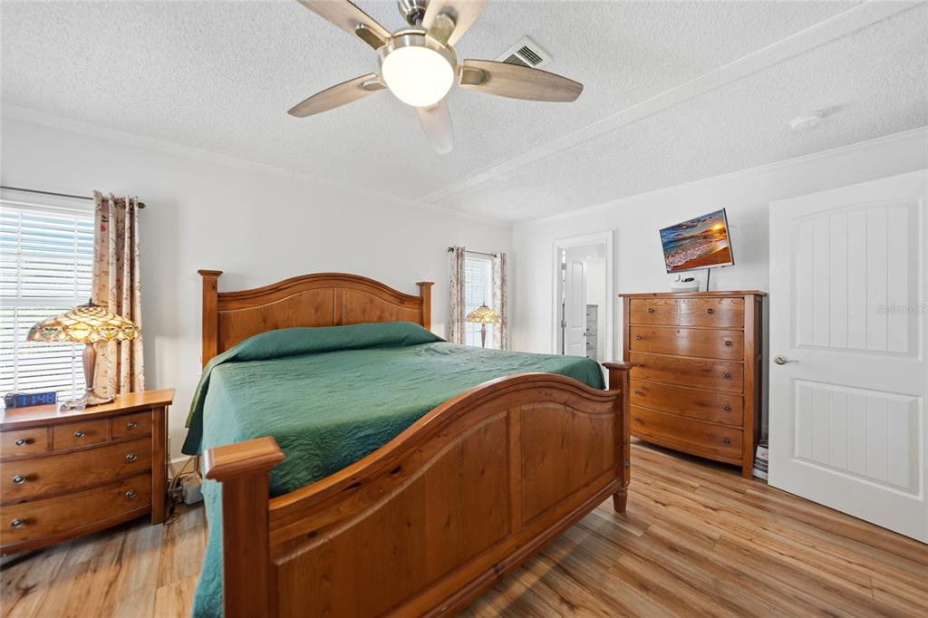 10303 Burnt Store Road, Unit 143 Punta Gorda, FL 33950 - Photo 13 of 42 a bedroom with a bed and wooden floor