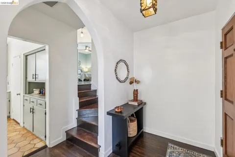 a view of a hallway with entryway wooden floor and front door
