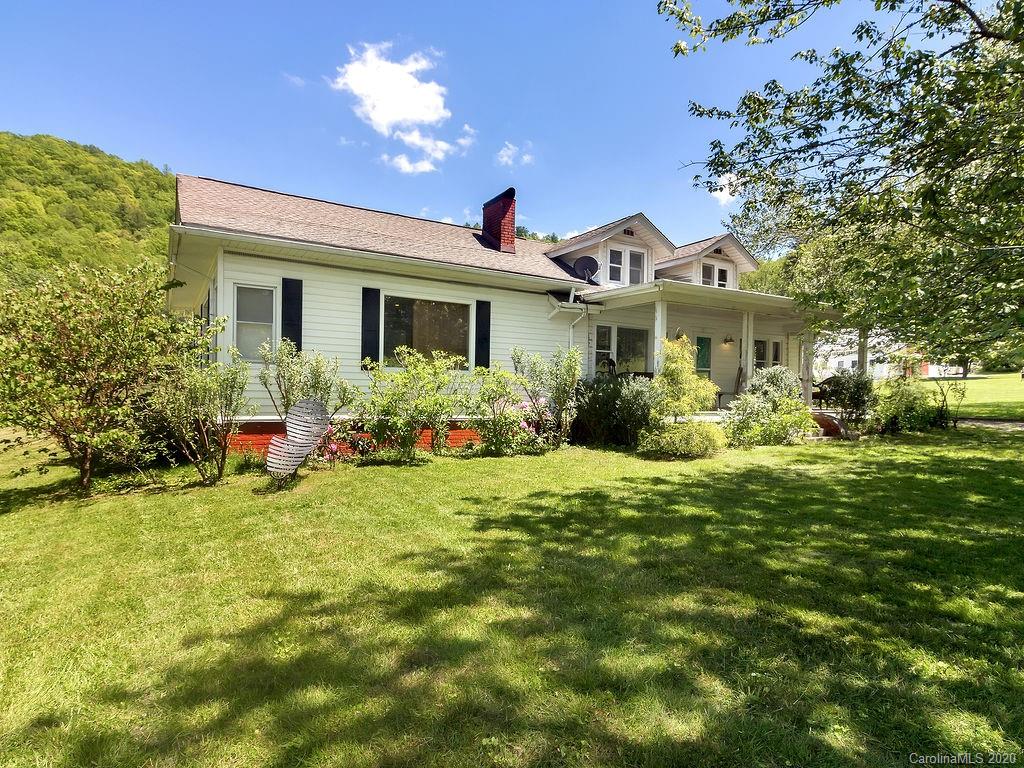 315 Shoals Falls Road Hendersonville, NC 28739 - Photo 2 of 47 a view of a house with a big yard and potted plants