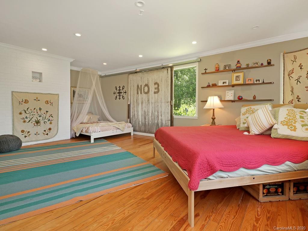 315 Shoals Falls Road Hendersonville, NC 28739 - Photo 14 of 47 a bedroom with a bed and a window