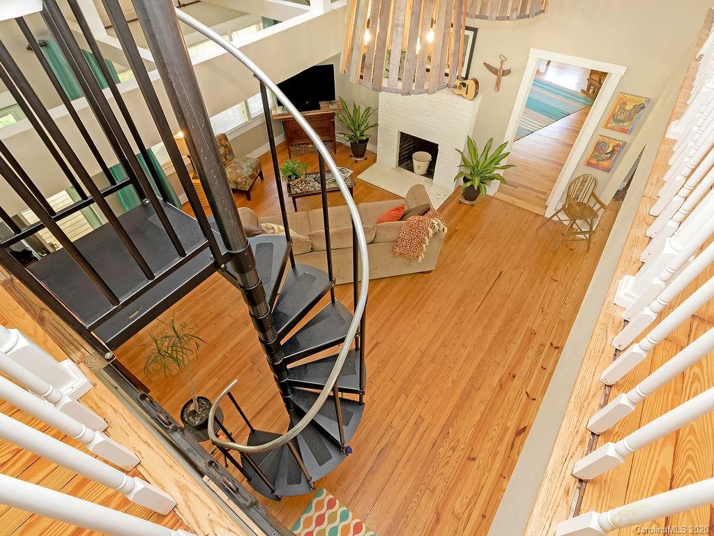 315 Shoals Falls Road Hendersonville, NC 28739 - Photo 15 of 47 a view of an chairs and table on the balcony