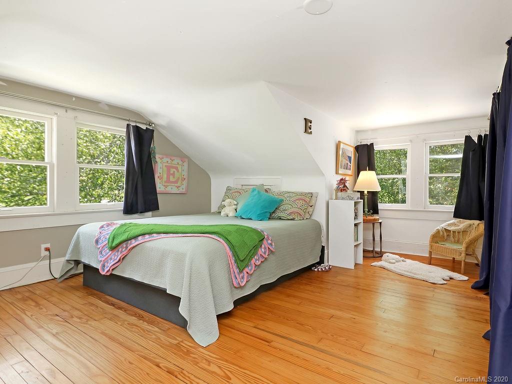 315 Shoals Falls Road Hendersonville, NC 28739 - Photo 16 of 47 a bedroom with a bed and wooden floor